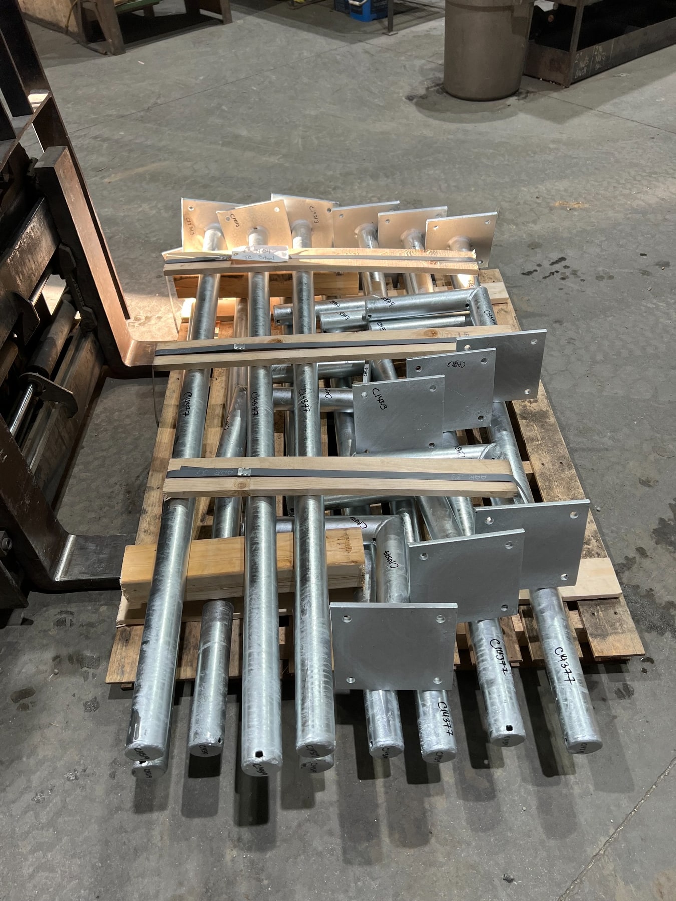 Steel instrument stands with drilled base plates secured on a pallet